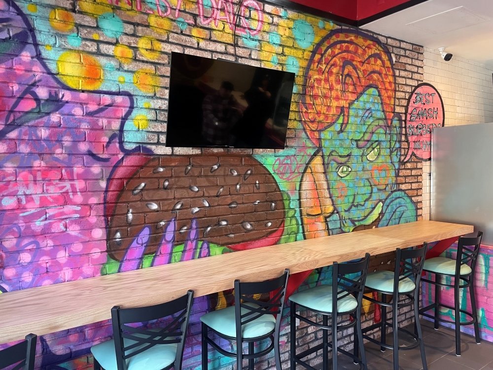Colorful Uncle Sal's graffiti dining wall and counter seating